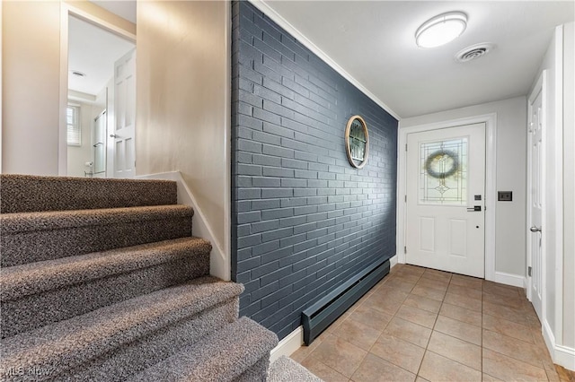 2615 Daffodil St NE, Canton, OH 44705 - entrance foyer featuring brick wall, light tile patterned floors, and stairs