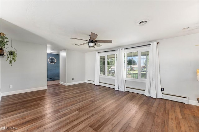 2615 Daffodil St NE, Canton, OH 44705 - empty room featuring baseboard heating, a ceiling fan, and wood finished floors