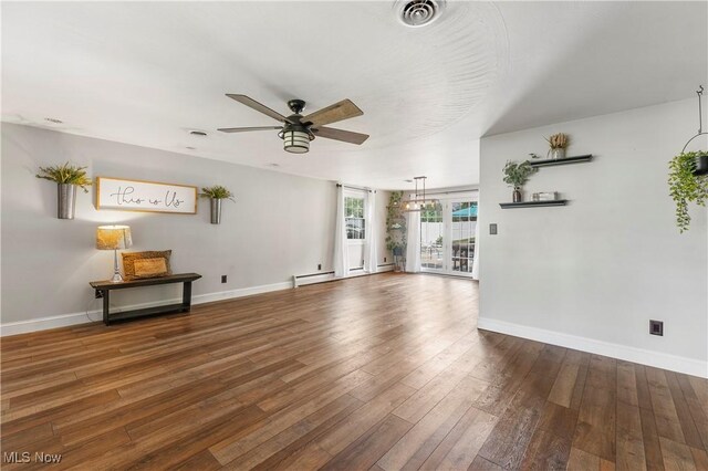 2615 Daffodil St NE, Canton, OH 44705 - unfurnished living room with a ceiling fan, hardwood / wood-style flooring, and a baseboard radiator