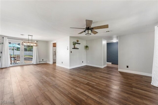 2615 Daffodil St NE, Canton, OH 44705 - unfurnished living room featuring ceiling fan, wood finished floors, and baseboard heating