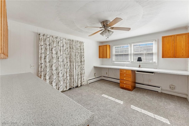 2615 Daffodil St NE, Canton, OH 44705 - kitchen featuring a baseboard heating unit, a ceiling fan, light countertops, and brown cabinets