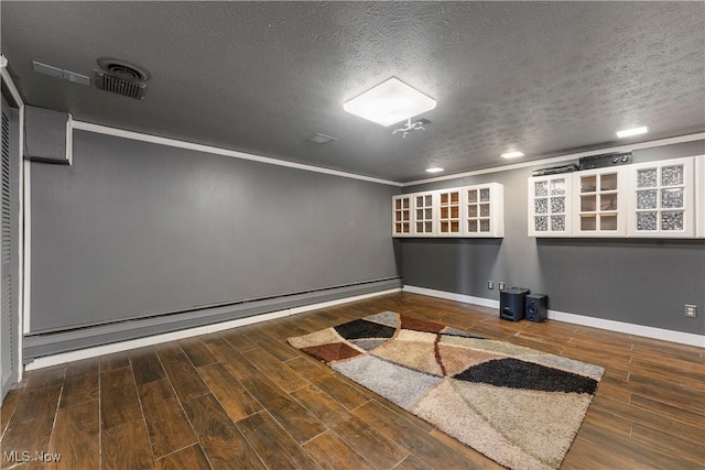 2615 Daffodil St NE, Canton, OH 44705 - empty room featuring wood finished floors, a textured ceiling, ornamental molding, a baseboard radiator, and recessed lighting