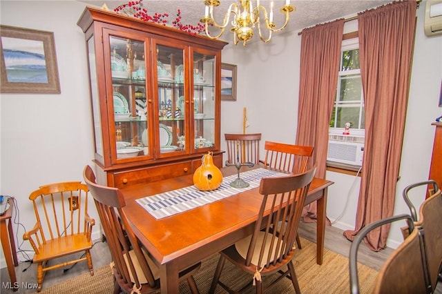 191 Ridgeland Dr, Toronto, OH 43964 - dining room with a chandelier, an AC wall unit, cooling unit, and wood finished floors