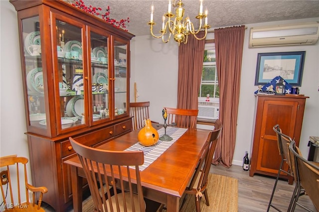 191 Ridgeland Dr, Toronto, OH 43964 - dining space featuring a wall mounted air conditioner, a chandelier, light wood-type flooring, cooling unit, and a textured ceiling