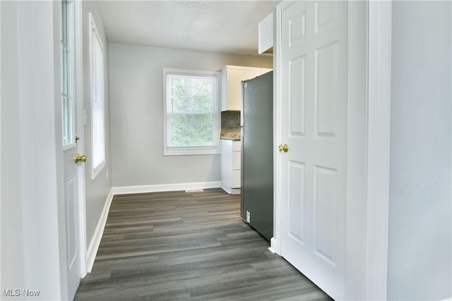 1006 Trumbull Ave, Warren, OH 44420 - unfurnished bedroom with freestanding refrigerator and dark wood-style flooring