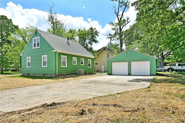 1006 Trumbull Ave, Warren, OH 44420 - view of property exterior with a detached garage, an outbuilding, and a shingled roof