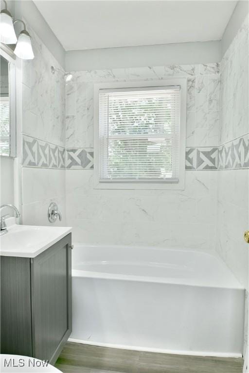 1006 Trumbull Ave, Warren, OH 44420 - full bath featuring vanity, wood finished floors, and shower / bath combination