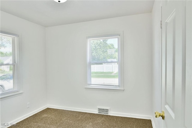 1006 Trumbull Ave, Warren, OH 44420 - empty room featuring dark colored carpet and baseboards