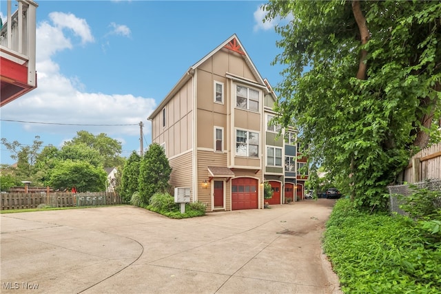 2395 Tremont Ave, Cleveland, OH 44113 - view of front of house featuring concrete driveway and an attached garage
