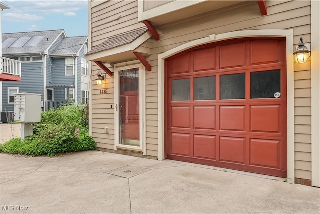 2395 Tremont Ave, Cleveland, OH 44113 - view of exterior entry featuring concrete driveway and a garage