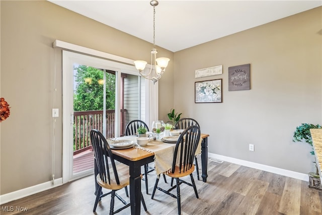 2395 Tremont Ave, Cleveland, OH 44113 - dining space featuring wood finished floors and a chandelier