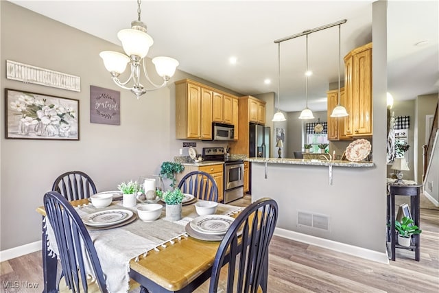 2395 Tremont Ave, Cleveland, OH 44113 - dining room with a chandelier, light wood-style floors, and recessed lighting