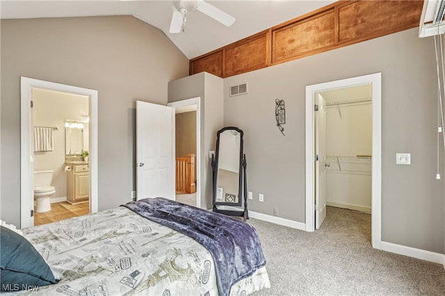 2395 Tremont Ave, Cleveland, OH 44113 - bedroom with a walk in closet, light colored carpet, a closet, high vaulted ceiling, and ensuite bath