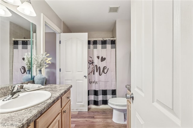2395 Tremont Ave, Cleveland, OH 44113 - bathroom with vanity, a shower with shower curtain, and wood finished floors