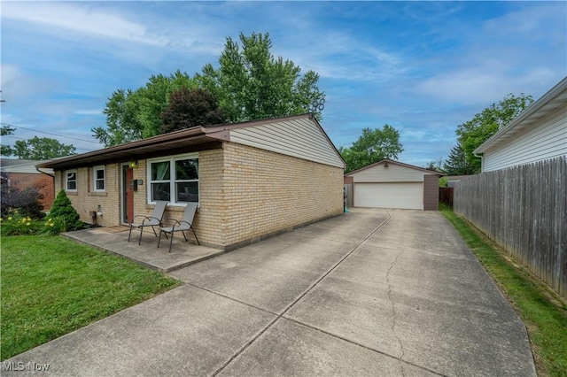 1291 Woodhurst Dr, Austintown, OH 44515 - view of side of home featuring brick siding, a garage, and an outdoor structure