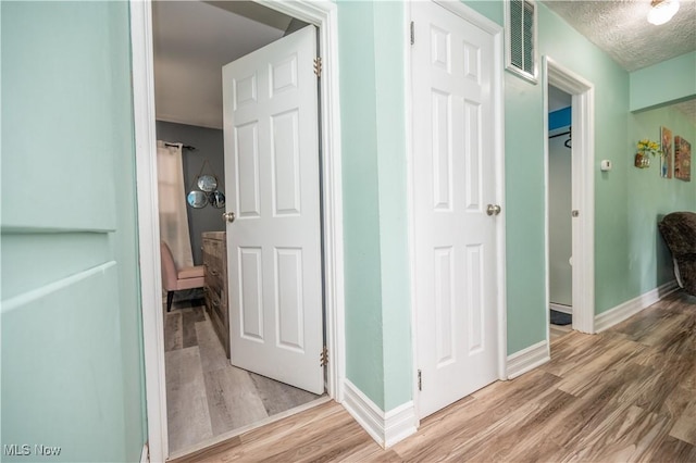 1291 Woodhurst Dr, Austintown, OH 44515 - hall with light wood finished floors and a textured ceiling