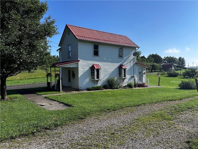 468 Carl St, Cumberland, OH 43732 - view of side of property featuring a yard, a metal roof, and a standing seam roof