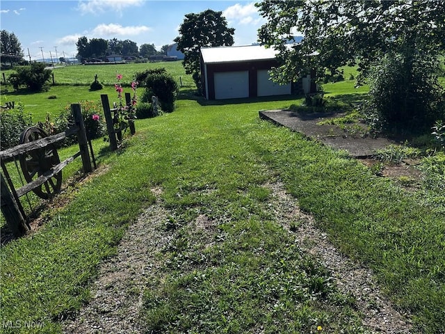 468 Carl St, Cumberland, OH 43732 - view of green lawn featuring an outbuilding and a detached garage