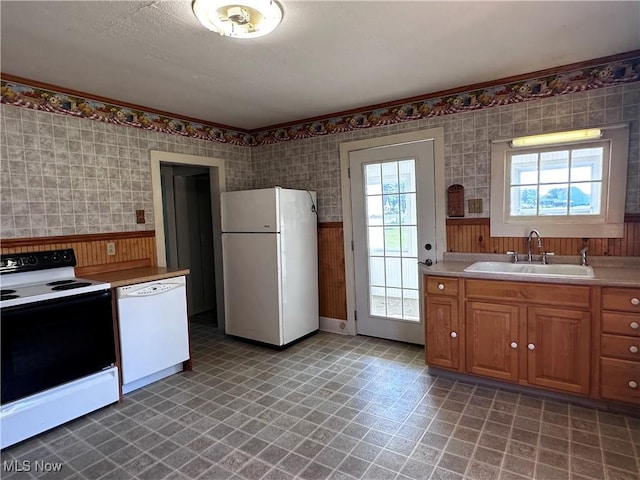 468 Carl St, Cumberland, OH 43732 - kitchen featuring white appliances, wainscoting, light floors, plenty of natural light, and wood walls