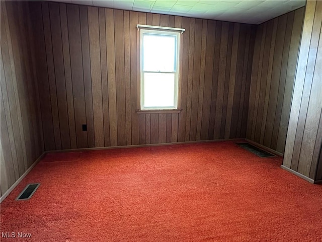 468 Carl St, Cumberland, OH 43732 - carpeted empty room featuring wood walls
