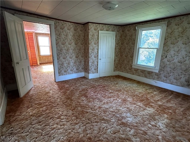 468 Carl St, Cumberland, OH 43732 - carpeted spare room featuring healthy amount of natural light, crown molding, and wallpapered walls