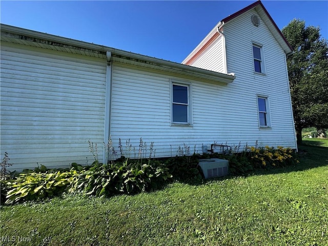 468 Carl St, Cumberland, OH 43732 - view of property exterior with a lawn and a central AC unit