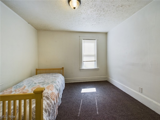237 E Thornton St, Akron, OH 44311 - carpeted bedroom with a textured ceiling and baseboards