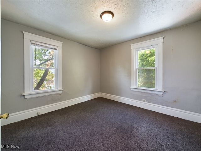 237 E Thornton St, Akron, OH 44311 - unfurnished room with plenty of natural light, dark carpet, and a textured ceiling