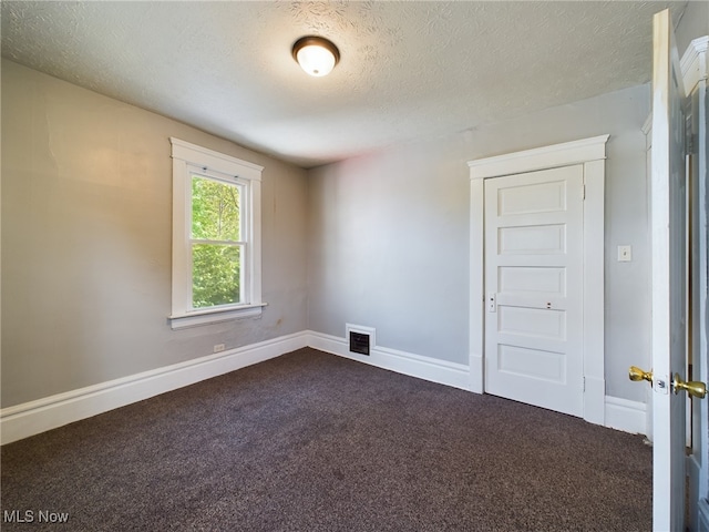237 E Thornton St, Akron, OH 44311 - unfurnished room featuring dark colored carpet and a textured ceiling