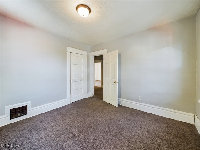 237 E Thornton St, Akron, OH 44311 - spare room with dark colored carpet and a textured ceiling