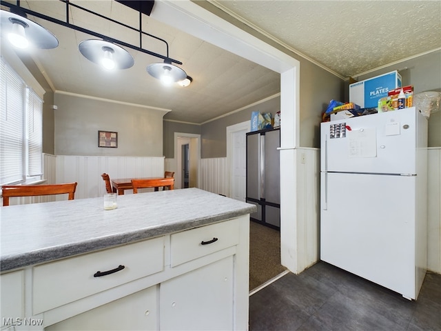 237 E Thornton St, Akron, OH 44311 - kitchen with freestanding refrigerator, crown molding, a wainscoted wall, white cabinets, and light countertops