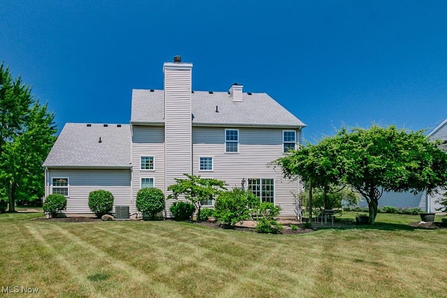 415 Cascade Ct, Avon Lake, OH 44012 - rear view of property featuring a yard, a chimney, and roof with shingles