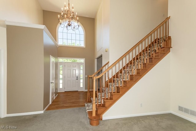 415 Cascade Ct, Avon Lake, OH 44012 - carpeted foyer featuring a towering ceiling, a chandelier, and stairs