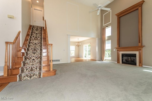 415 Cascade Ct, Avon Lake, OH 44012 - unfurnished living room with a high ceiling, a fireplace, a chandelier, carpet flooring, and stairway