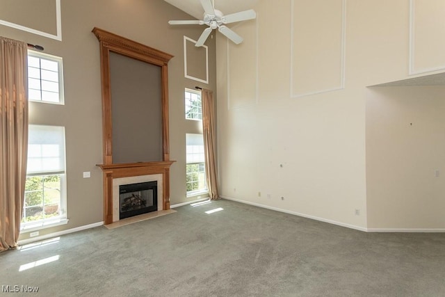 415 Cascade Ct, Avon Lake, OH 44012 - unfurnished living room with a high ceiling, carpet flooring, a high end fireplace, ceiling fan, and healthy amount of natural light