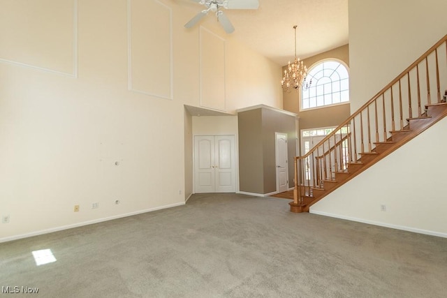 415 Cascade Ct, Avon Lake, OH 44012 - unfurnished living room with a towering ceiling, carpet, and stairway