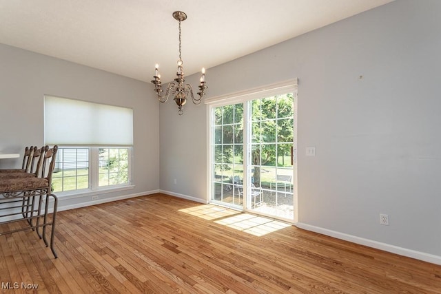 415 Cascade Ct, Avon Lake, OH 44012 - unfurnished dining area featuring a chandelier and light wood-type flooring