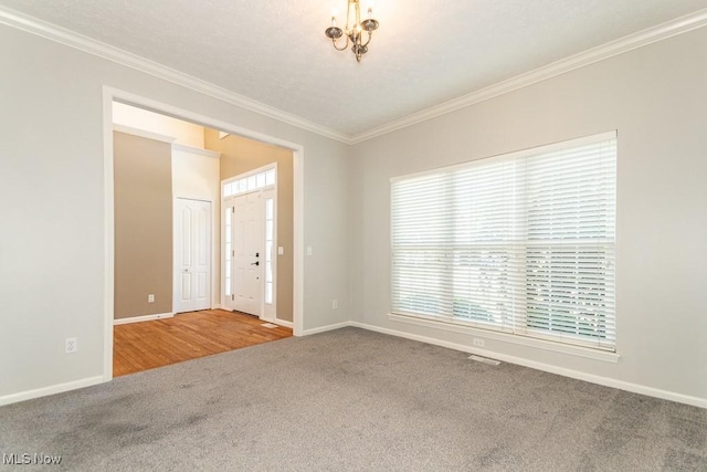 415 Cascade Ct, Avon Lake, OH 44012 - carpeted empty room with ornamental molding and a chandelier