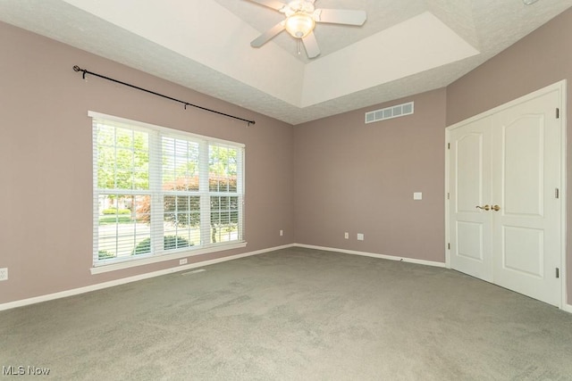 415 Cascade Ct, Avon Lake, OH 44012 - unfurnished room with carpet flooring, a ceiling fan, and a tray ceiling