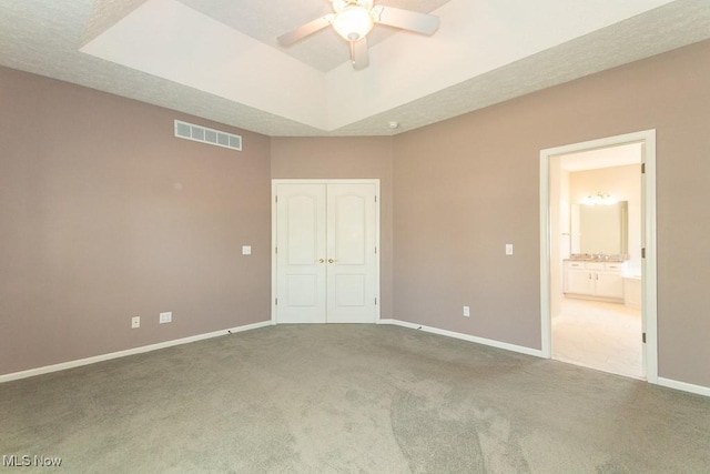 415 Cascade Ct, Avon Lake, OH 44012 - unfurnished bedroom featuring carpet, a raised ceiling, a closet, and ensuite bath
