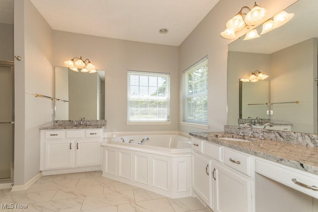 415 Cascade Ct, Avon Lake, OH 44012 - full bathroom featuring marble finish flooring, a bath, and two vanities