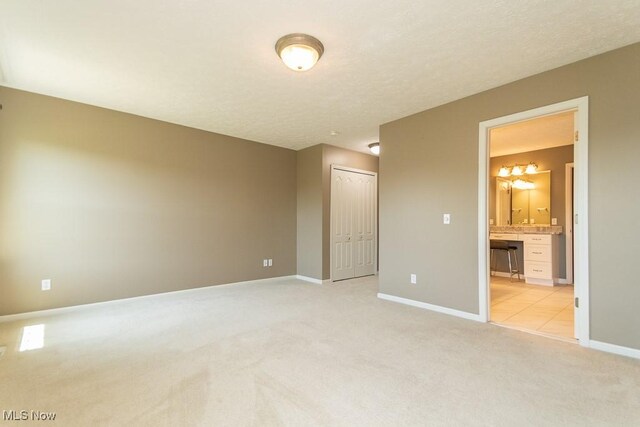 415 Cascade Ct, Avon Lake, OH 44012 - unfurnished bedroom featuring light colored carpet, a closet, and ensuite bathroom