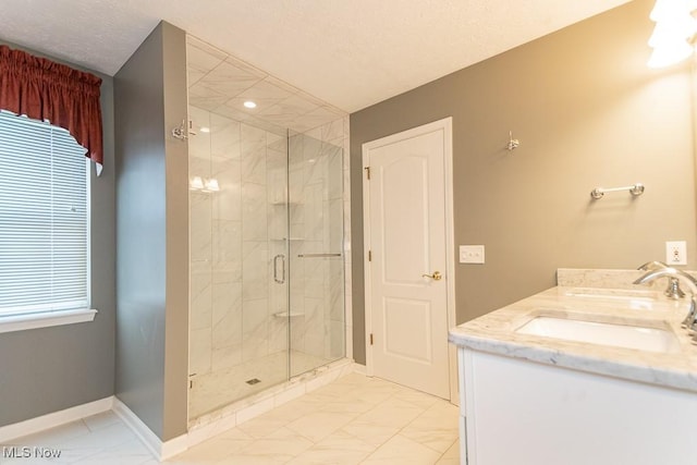 415 Cascade Ct, Avon Lake, OH 44012 - bathroom featuring a shower stall, marble look tile flooring, double vanity, and a textured ceiling