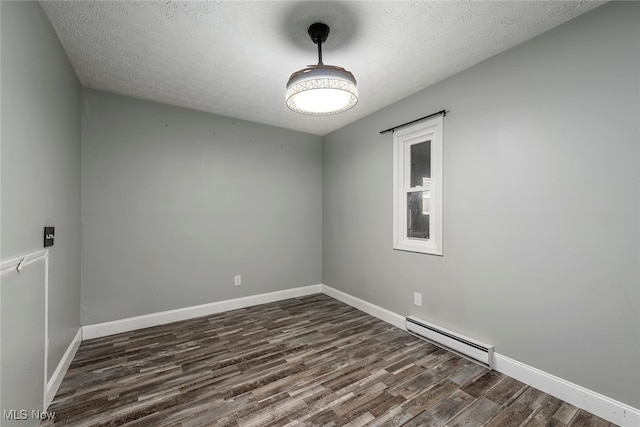 1915 Claus Rd, Vermilion, OH 44089 - empty room with a baseboard heating unit, dark wood finished floors, and a textured ceiling