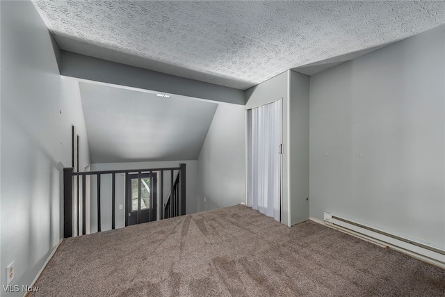 1915 Claus Rd, Vermilion, OH 44089 - spare room with a baseboard radiator, carpet, lofted ceiling, and a textured ceiling