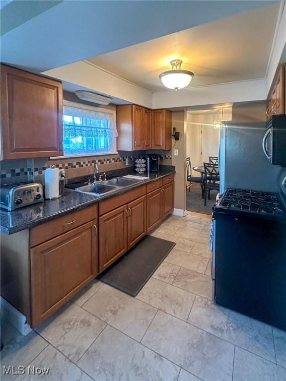 4926 E Wallings Rd, Broadview Heights, OH 44147 - kitchen featuring appliances with stainless steel finishes, backsplash, dark countertops, and brown cabinets