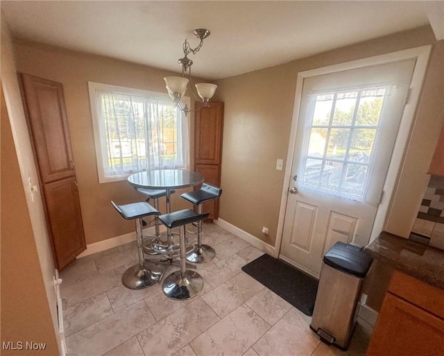 4926 E Wallings Rd, Broadview Heights, OH 44147 - dining area featuring a chandelier and baseboards