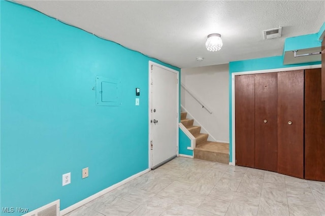 6480 State Rd Unit F7, Parma, OH 44134 - foyer entrance featuring stairway, electric panel, and a textured ceiling