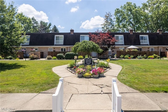 6480 State Rd Unit F7, Parma, OH 44134 - view of front of home with mansard roof, brick siding, and a chimney