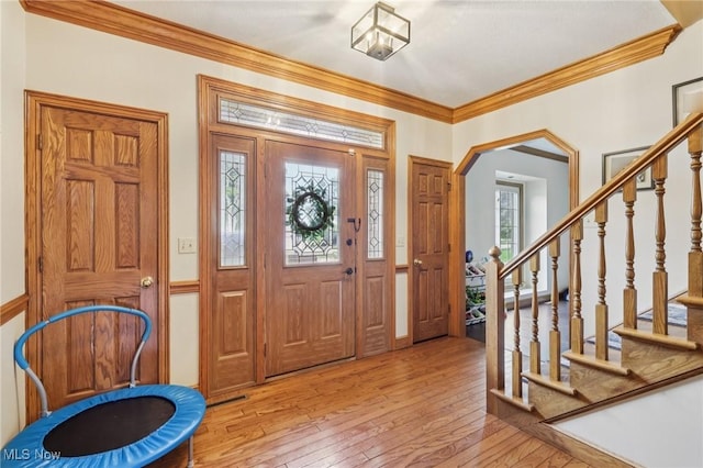 1101 Partridge Dr, Wadsworth, OH 44281 - entryway featuring hardwood / wood-style flooring, ornamental molding, stairs, and arched walkways